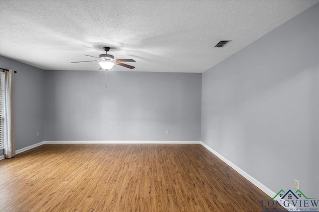 1611 Springdale St, Longview, TX 75604 - empty room featuring ceiling fan, wood finished floors, baseboards, and a textured ceiling