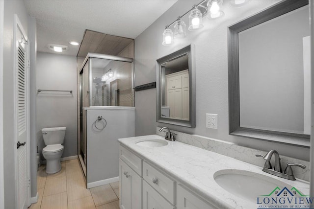 1611 Springdale St, Longview, TX 75604 - bathroom with a shower stall, toilet, and double vanity