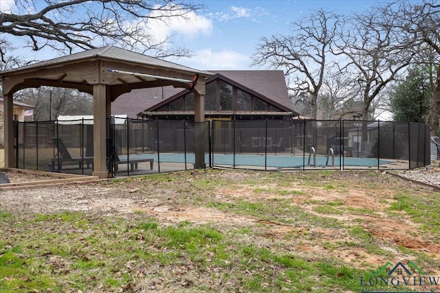 view of yard featuring a fenced in pool and a gazebo