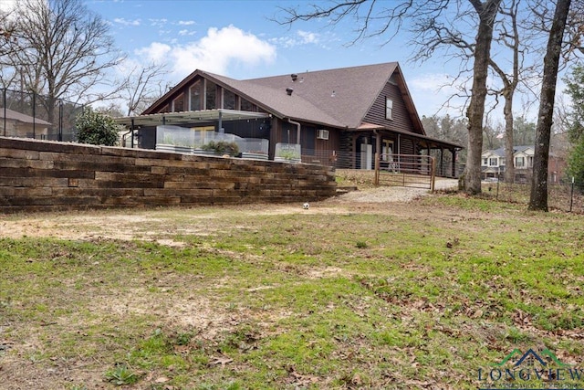 rear view of property featuring a yard