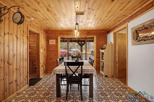 carpeted bedroom featuring lofted ceiling, wooden walls, and wood ceiling