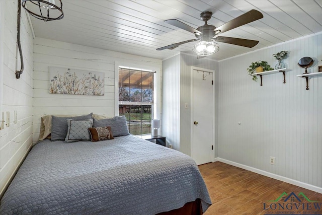 bedroom with hardwood / wood-style floors and ceiling fan