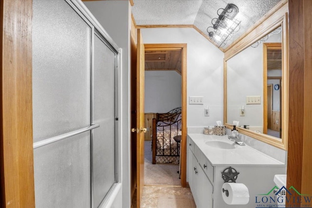 bathroom featuring vanity, lofted ceiling, a textured ceiling, and a shower with shower door