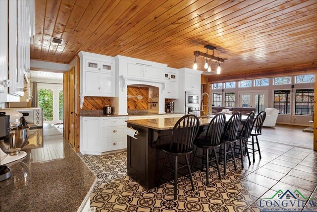 office featuring ceiling fan, wood ceiling, dark hardwood / wood-style floors, and built in shelves