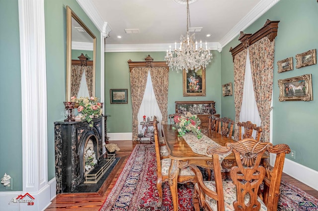 dining space featuring a chandelier, hardwood / wood-style floors, and ornamental molding