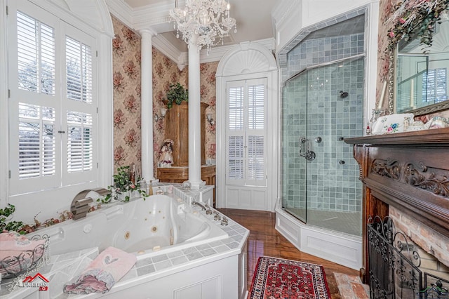 bathroom featuring a wealth of natural light, ornamental molding, independent shower and bath, and decorative columns