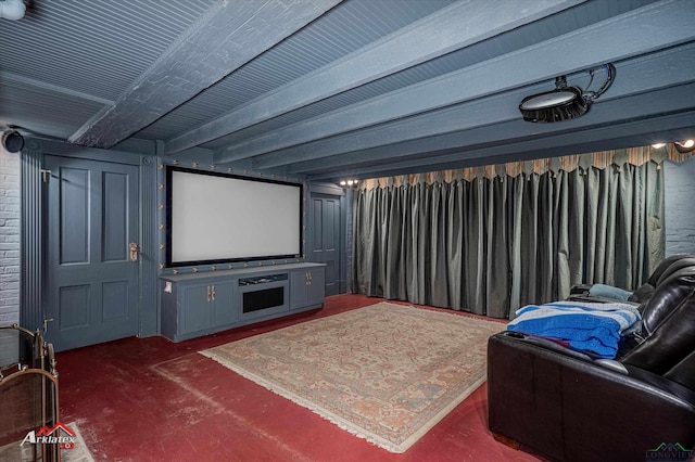 carpeted cinema room with beamed ceiling