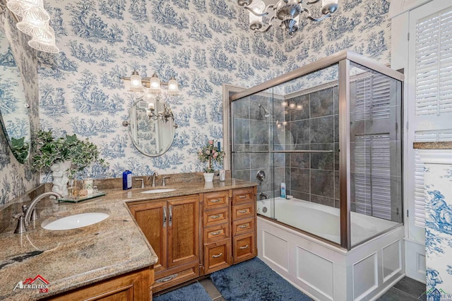 bathroom featuring tile patterned floors, vanity, enclosed tub / shower combo, and an inviting chandelier