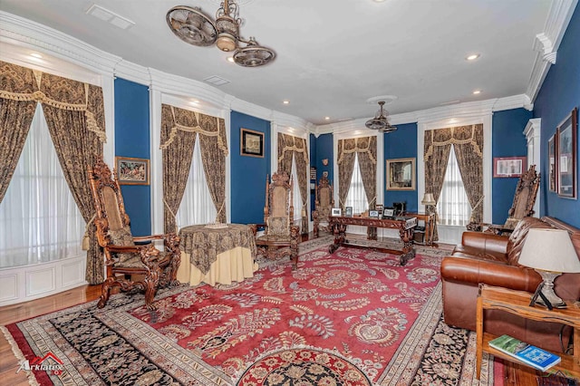 interior space featuring hardwood / wood-style flooring, ceiling fan, and ornamental molding