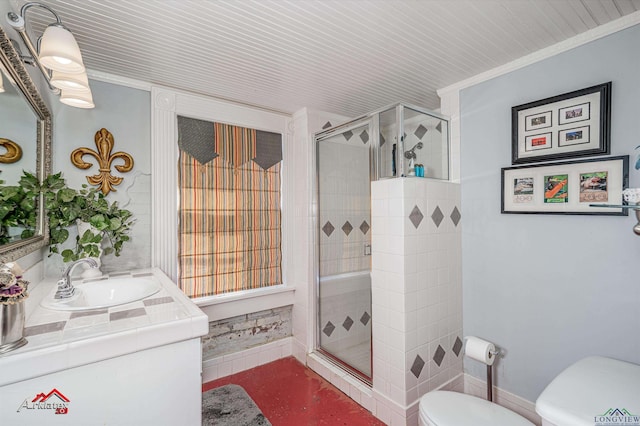 bathroom with vanity, toilet, and a shower with shower door