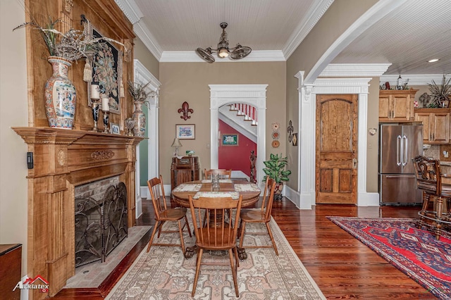 dining room featuring dark wood-type flooring and crown molding