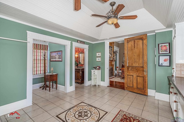 interior space with ceiling fan, crown molding, and wood ceiling