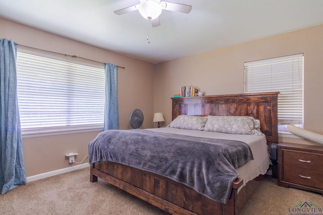 carpeted bedroom with multiple windows and ceiling fan