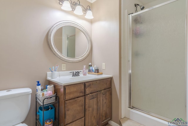 bathroom featuring an enclosed shower, vanity, and toilet