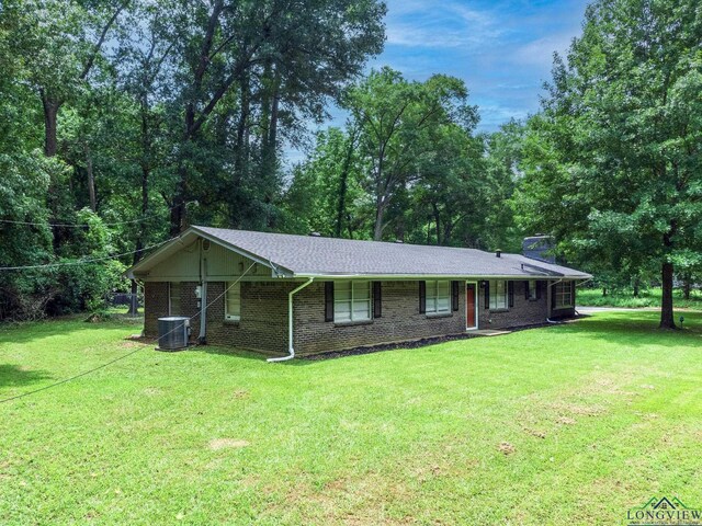 single story home featuring central AC unit and a front yard