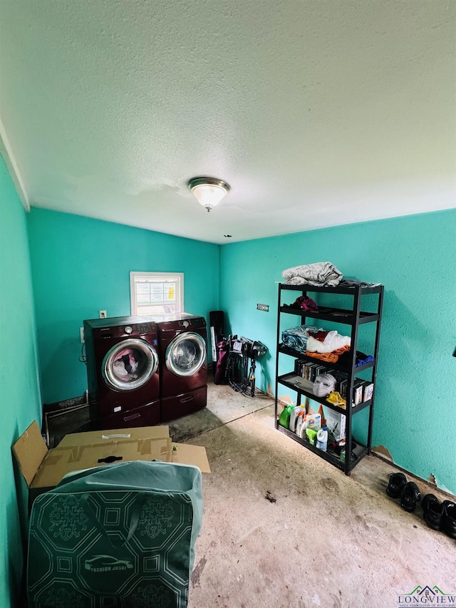 laundry area featuring separate washer and dryer and a textured ceiling