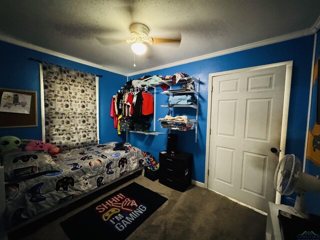 carpeted bedroom with ceiling fan, crown molding, and a textured ceiling