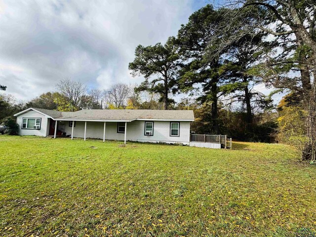 rear view of house with a lawn