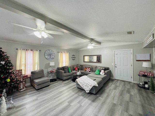 living room featuring ceiling fan, crown molding, light hardwood / wood-style floors, and a textured ceiling