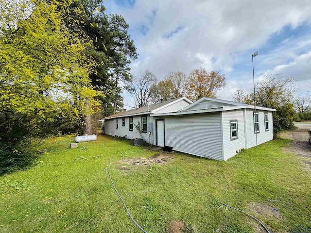 rear view of house with a lawn