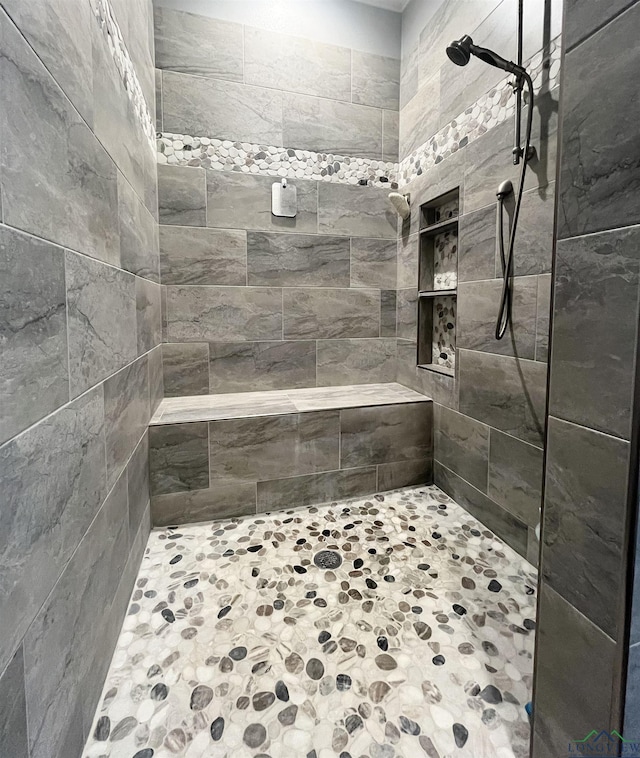 full bath with tiled shower