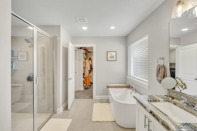 17182 Ironwood Dr, Flint, TX 75762 - full bathroom featuring a stall shower, vanity, a walk in closet, a soaking tub, and recessed lighting