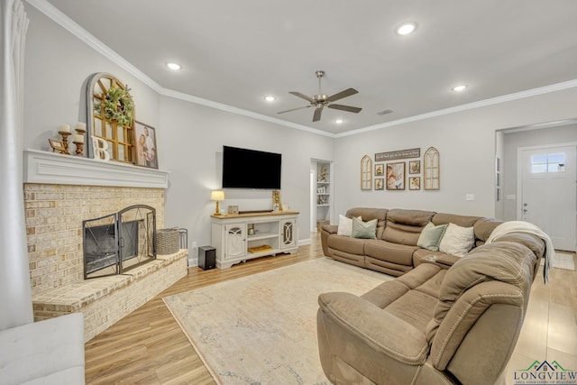 17182 Ironwood Dr, Flint, TX 75762 - living room featuring a ceiling fan, wood finished floors, recessed lighting, ornamental molding, and a brick fireplace