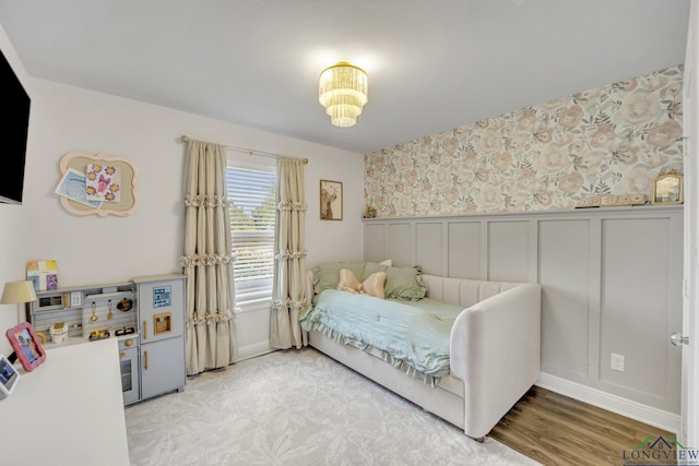 17182 Ironwood Dr, Flint, TX 75762 - bedroom featuring a wainscoted wall, a decorative wall, wood finished floors, and wallpapered walls
