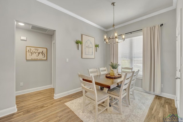 17182 Ironwood Dr, Flint, TX 75762 - dining room featuring light wood-style flooring, a chandelier, and crown molding