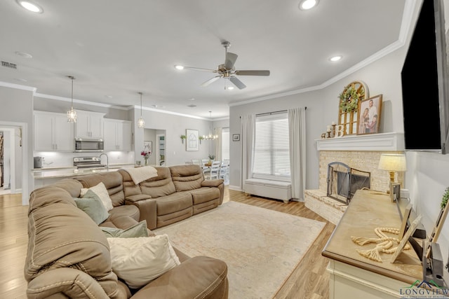 17182 Ironwood Dr, Flint, TX 75762 - living room with a ceiling fan, recessed lighting, crown molding, light wood-style floors, and a fireplace