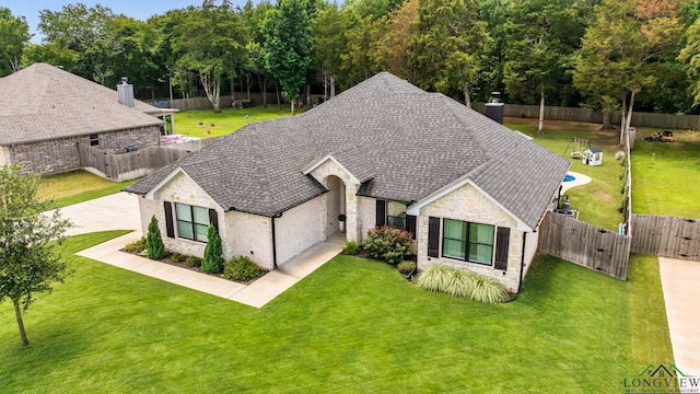 17182 Ironwood Dr, Flint, TX 75762 - view of front facade featuring stone siding, a gate, a fenced backyard, and roof with shingles