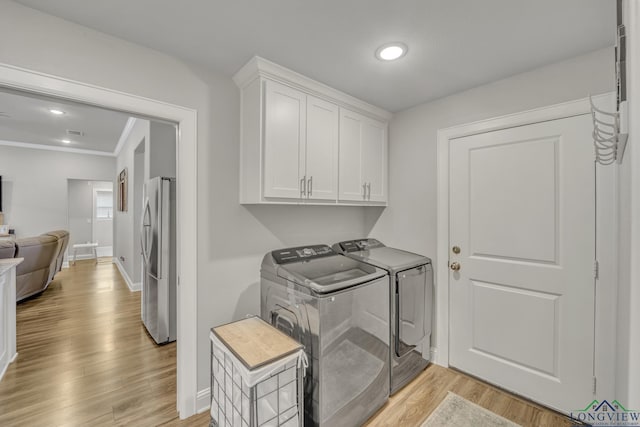 17182 Ironwood Dr, Flint, TX 75762 - washroom featuring separate washer and dryer, cabinet space, light wood-style flooring, and recessed lighting