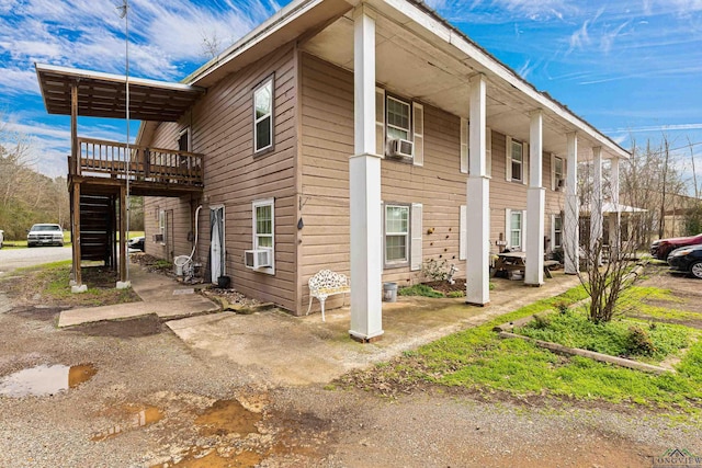 view of side of property with cooling unit and a deck