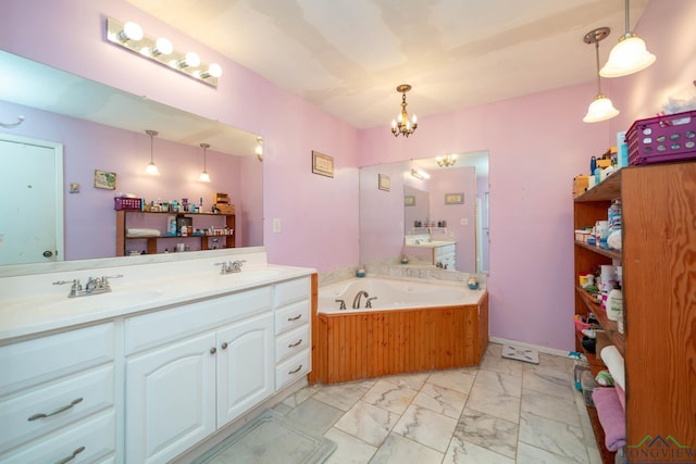 bathroom featuring a notable chandelier, marble finish floor, a sink, double vanity, and a bath