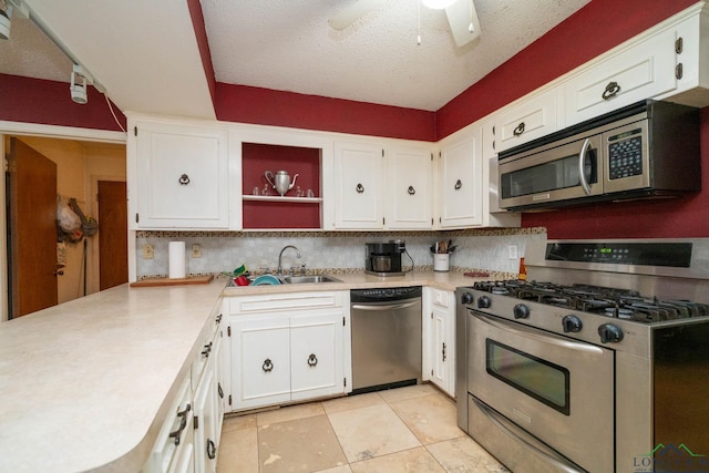 kitchen with white cabinets, appliances with stainless steel finishes, light countertops, and a sink