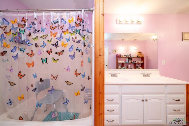 full bath featuring double vanity, a shower with shower curtain, and a sink