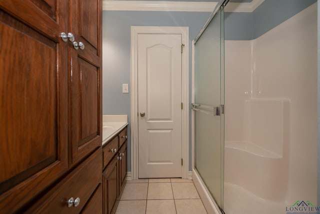 bathroom featuring tile patterned flooring, vanity, an enclosed shower, and ornamental molding