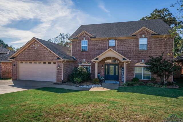 view of front of property featuring a garage and a front yard