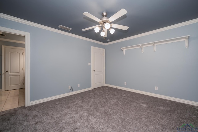 spare room with ceiling fan, carpet floors, and ornamental molding