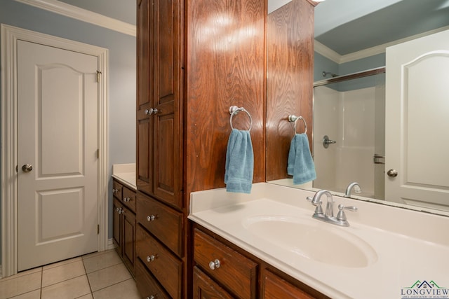 bathroom featuring tile patterned floors, crown molding, and vanity