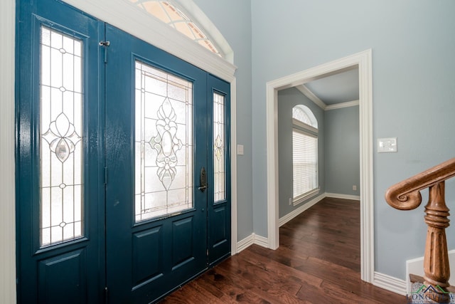 foyer with dark wood-type flooring and ornamental molding