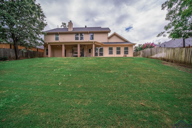 rear view of house with a lawn