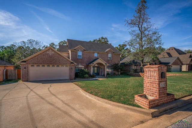 view of front of property with a front yard and a garage