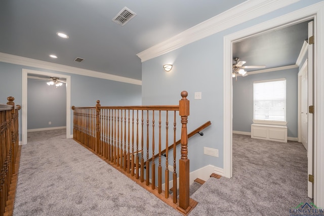 hall with light carpet and ornamental molding