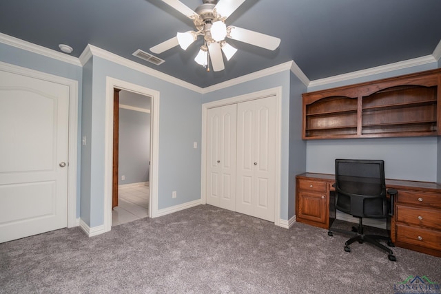 unfurnished office with carpet flooring, ceiling fan, and crown molding