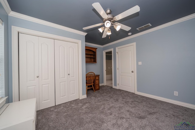 unfurnished bedroom with a closet, dark carpet, ceiling fan, and crown molding