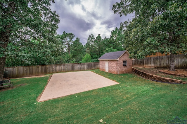 view of yard with an outbuilding and a patio