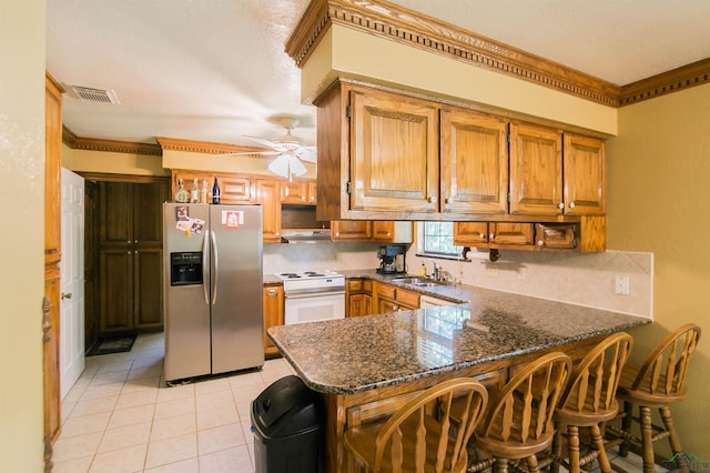 kitchen with stainless steel refrigerator with ice dispenser, kitchen peninsula, dark stone countertops, white range with electric cooktop, and light tile patterned floors