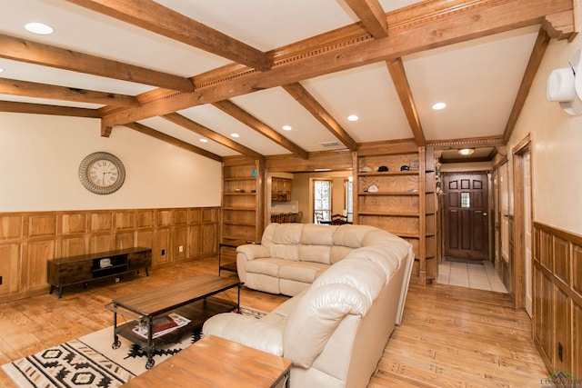 living room featuring vaulted ceiling with beams, light wood-type flooring, and wooden walls