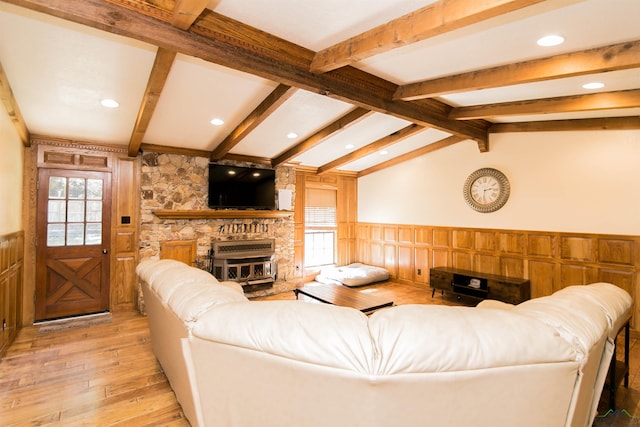 living room with vaulted ceiling with beams and light hardwood / wood-style flooring